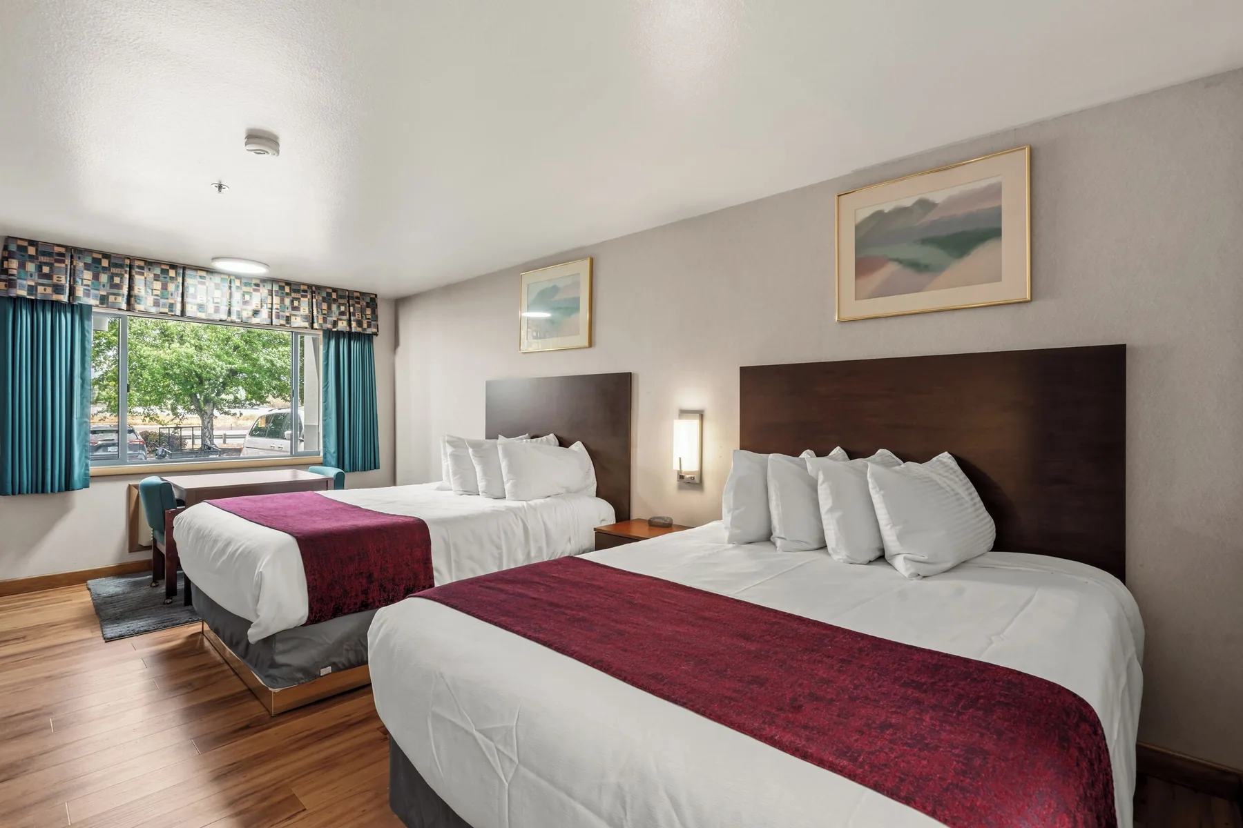 Two Queen guest room with a window and bedside table