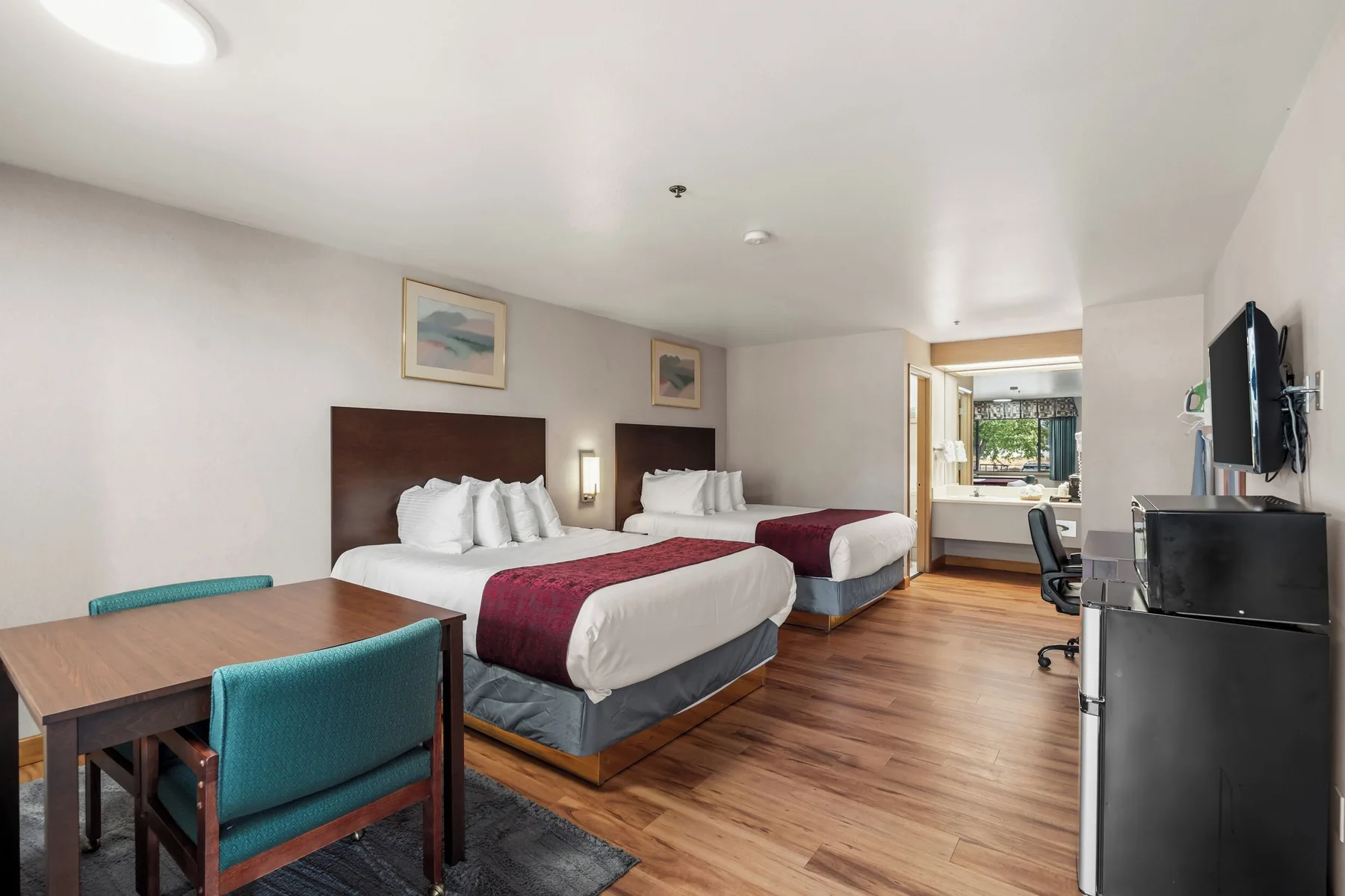 Two Queen guest room with a table, mini-fridge, and microwave